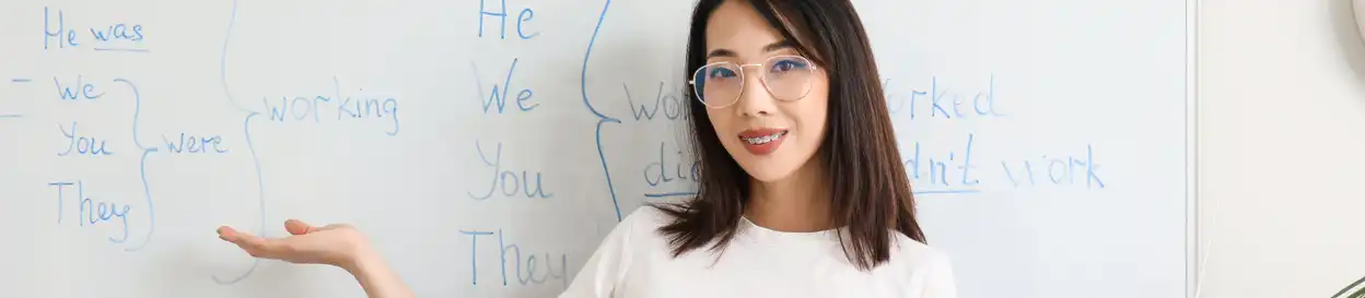 a school teacher in front of a whiteboard