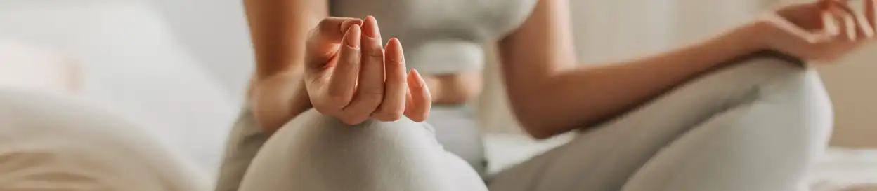 A woman in gym gear doing yoga