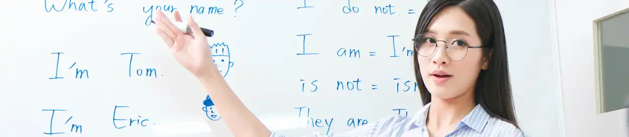 A teacher points to a whiteboard and leads an English class