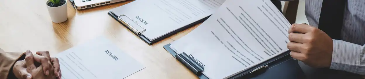 A resume being reviewed by an interview panel