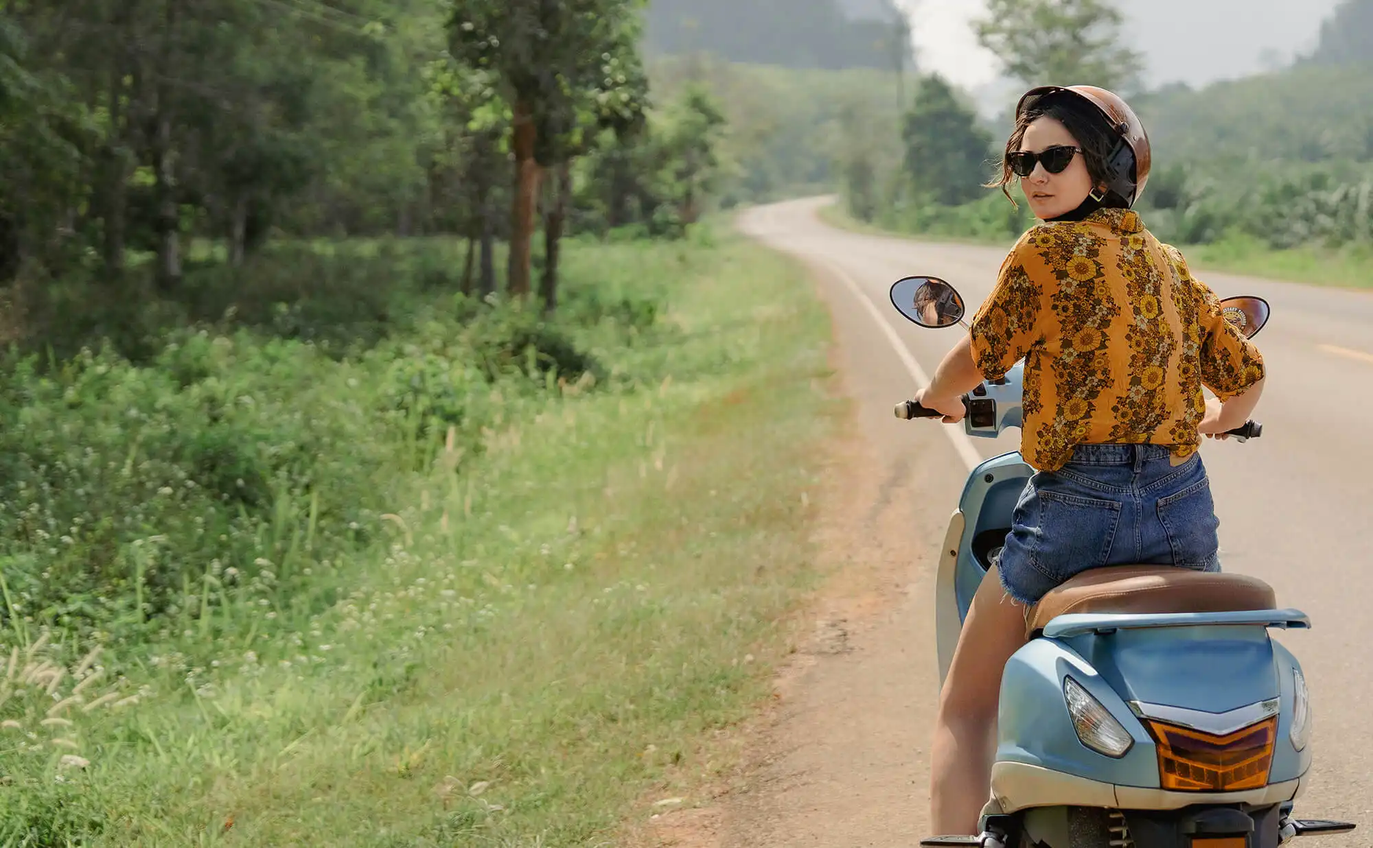 Woman on motrobike travelling in Asia